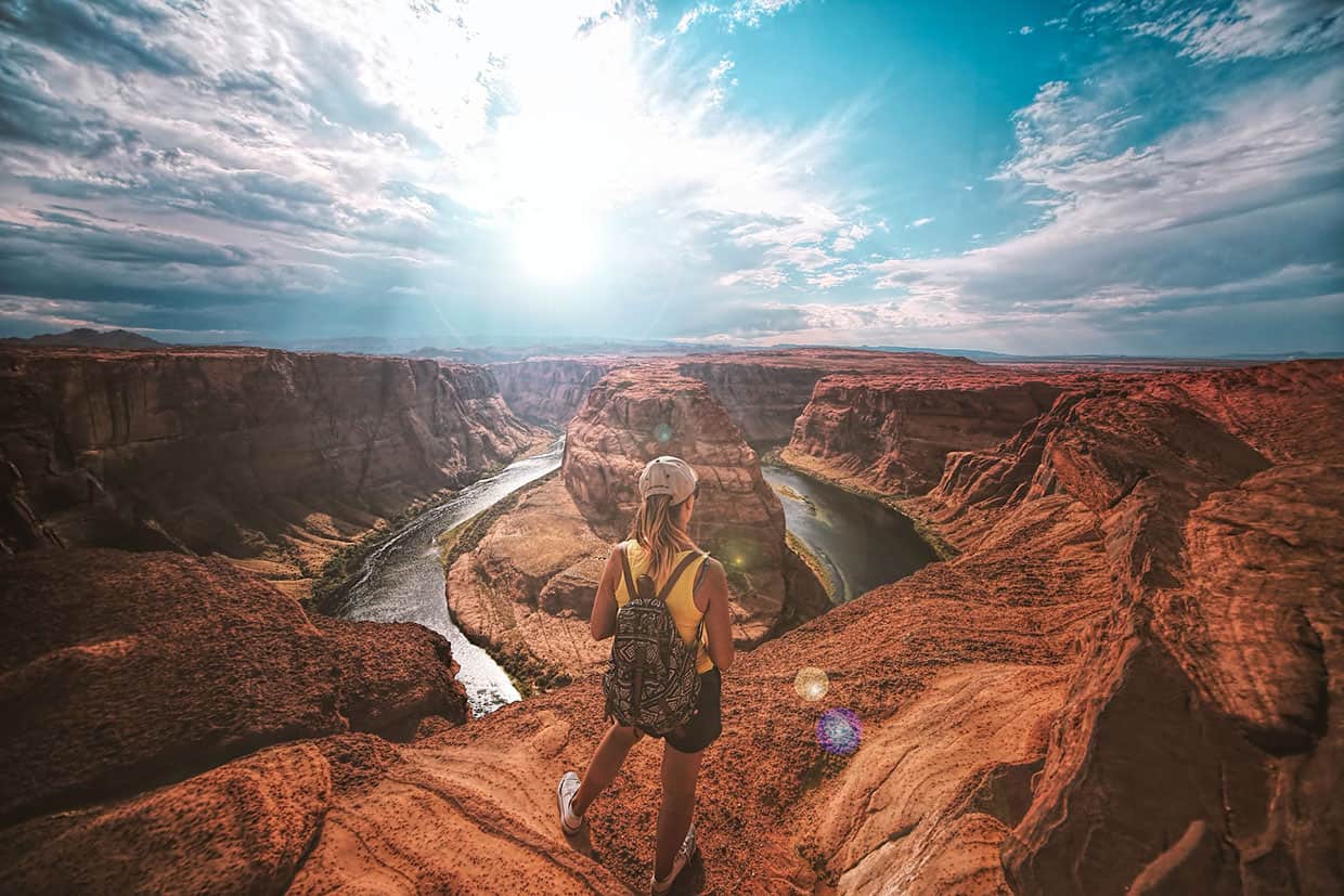 Curabitur lorem magna scelerisque a purus nec 1 Woman standing on top of canyon